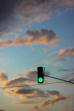 Green traffic light: traffic on the road, urban life.
