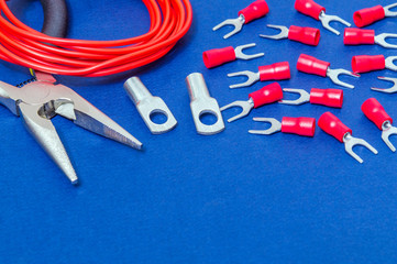Kit spare parts and tool, red wires for electrical prepared before repair or setting on blue...