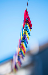 colourful clothes pegs on a rope
