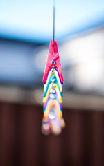 colourful clothes pegs on a rope