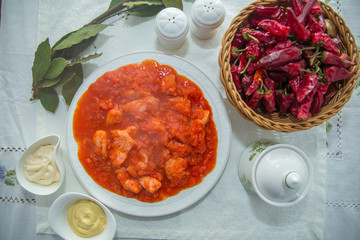 Tomato Pickle . Chicken and tomatoes . Red Dry Pepper in Traditional Basket . Tomato Pickle . Chakhokhbili - chicken stewed with tomatoes and onions. salt, pepper. Red Dry Pepper in Basket .