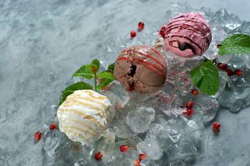 three balls of ice cream are lying on the ice