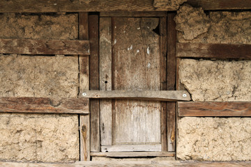 Humble wooden window in adobe house