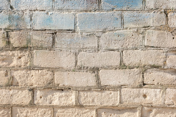 old grey brickwall texture with blue paint brughstrokes on it