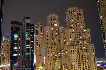 Fototapeta na wymiar Highrise buildings at Dubai Marina illuminated at night