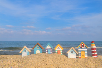 Miniature huts and lighthouse at beach