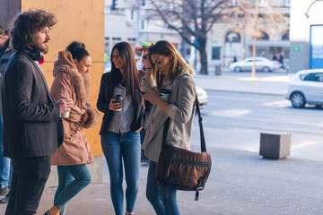 Friends Bonding, group of multi-ethnic friends walking on the streets talking to each other and...