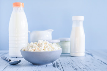 Set of healthy dairy products on a blue background. Kefir, milk, cottage cheese. Dietary foods.