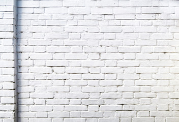 Three- dimensional elements of brickwork on the wall. Terraces on an old brick wall. Old weathered white brick.