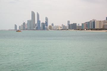 Fototapeta premium on the beach against the backdrop of Abu Dhabi buildings