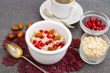 Healthy eating, breakfast. Oatmeal with pomegranate and nuts, black coffee.