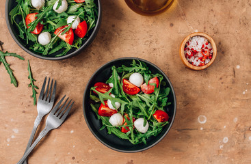 arugula salad with mozzarella cheese and cherry tomatoes