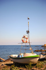 A small lifeboat on the beach.