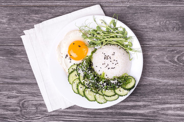 Rice with cucumber, scrambled eggs, microgreen and Japanese wakame seaweed salad.