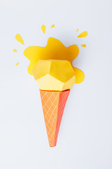 Summer background made of yellow origami paper ice cream. Minimal creative concept.