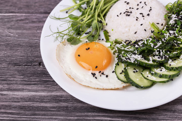 Rice with cucumber, scrambled eggs, microgreen and Japanese wakame seaweed salad.
