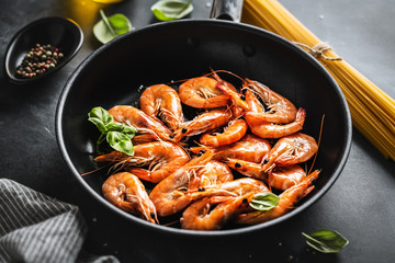 Fried shrimps with spices on pan