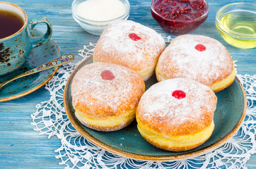 Traditional food doughnuts with icing sugar and jam. Concept and background Jewish holiday Hanukkah.