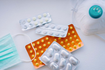 pills and nebulizer with medical mask on a white background