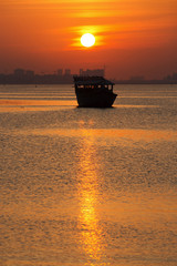 Sunrise and Silhouette of a Dhow