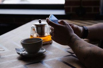 hand holding a glass of tea
