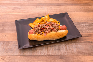 Hot dog with bacon and French fries garnish