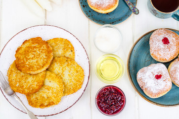 Concept and background Jewish holiday Hanukkah. Traditional food doughnuts and potatoes pancakes latkes. Flat lay or top view.