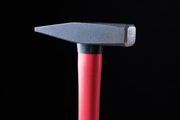 top of the hammer for the nails on a black background. high quality, beautiful color, high definition. space for text and ads. copy paste and copyright