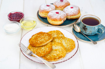 Concept and background Jewish holiday Hanukkah. Traditional food doughnuts and potatoes pancakes latkes. Flat lay or top view.