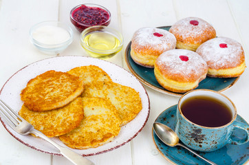 Concept and background Jewish holiday Hanukkah. Traditional food doughnuts and potatoes pancakes latkes. Flat lay or top view.