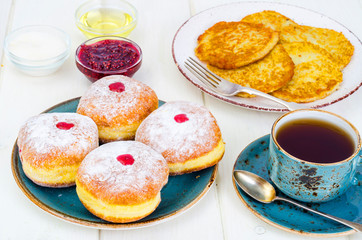 Concept and background Jewish holiday Hanukkah. Traditional food doughnuts and potatoes pancakes latkes. Flat lay or top view.