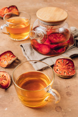 Bael fruit juice or quince tea and dried bael sliced fruit on rustic background. Thai or Asian healthy drink. Bael is helping the body to resist catching a cold.