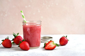 Fresh delicious strawberry banana smoothie in a mason jar.