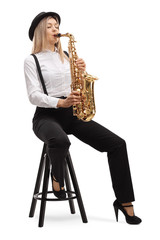 Young blond female artist playing a saxophone