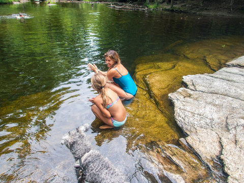 Mother and daughter in a  mountain river