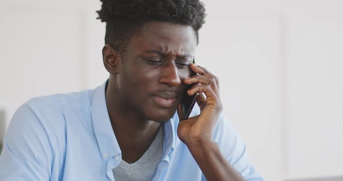 Upset african guy talking with his ex girlfriend by phone