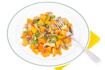 White plate with vegetarian food of vegetables, pumpkin, mushrooms