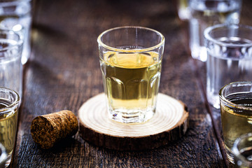 Small dose of high quality distilled alcohol. Brazilian silver cachaça, called pinga, along with glasses of vodka, white rum, Poitín, and absinthe.