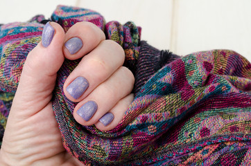 Hand of an adult woman with painted nails, manicure, nail polish