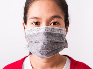 closeup woman wearing face mask protective against coronavirus or COVID-19 virus