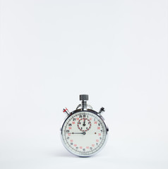 Analogic vintage chronometer clock with red and black numbers on white background