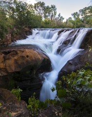 Soninho river waterfalls, in Jalapao, Brazil. Crystal clear water, blue sky. Slow shutter speed used to smooth the water.
