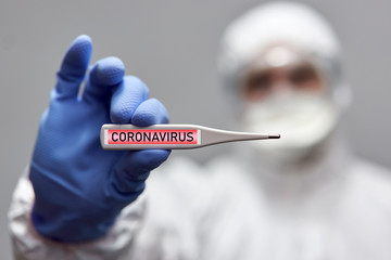 Man holding a thermometer with coronavirus alert