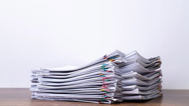 Stack overload document report paper with colorful paperclip place and copy space on black background, business concept footage paperless used &ndash; 4K Stop motion.