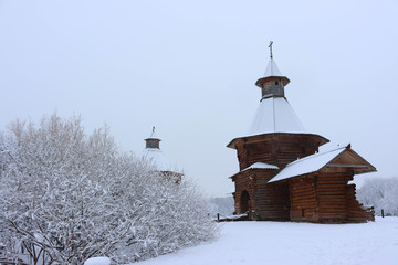 Museum of wooden architecture in Kolomenskoye during snowfall. Travel gates of the Nikolo-Korelsky monastery in Kolomenskoye estate, Moscow, Russia