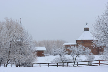 Museum of wooden architecture in Kolomenskoye during snowfall. The tower of the Bratsk fortress and the Gates of the Nikolo-Korelsky monastery in Kolomenskoye estate, Moscow, Russia