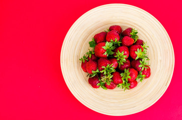 Ripe sweet farmer red strawberries on wooden dish