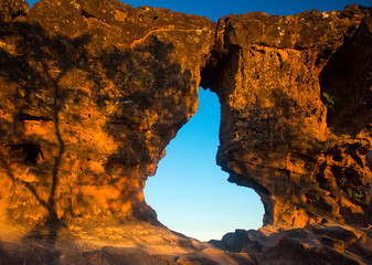Sunset view trhouogh the rock hole (Pedra furada), in Portal da chapada, a trourist attraction in Chapada das mesas, Brazil
