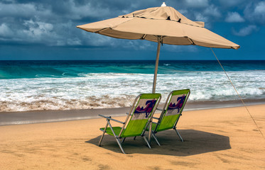 A pair of chairs, waiting for a couple to enjoy the ocean view, in Fernando de Noronha, Brazil.