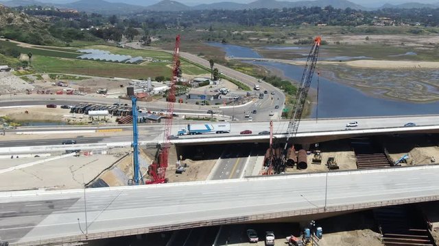 Aerial view of highway bridge construction over small river, San Diego, California, USA